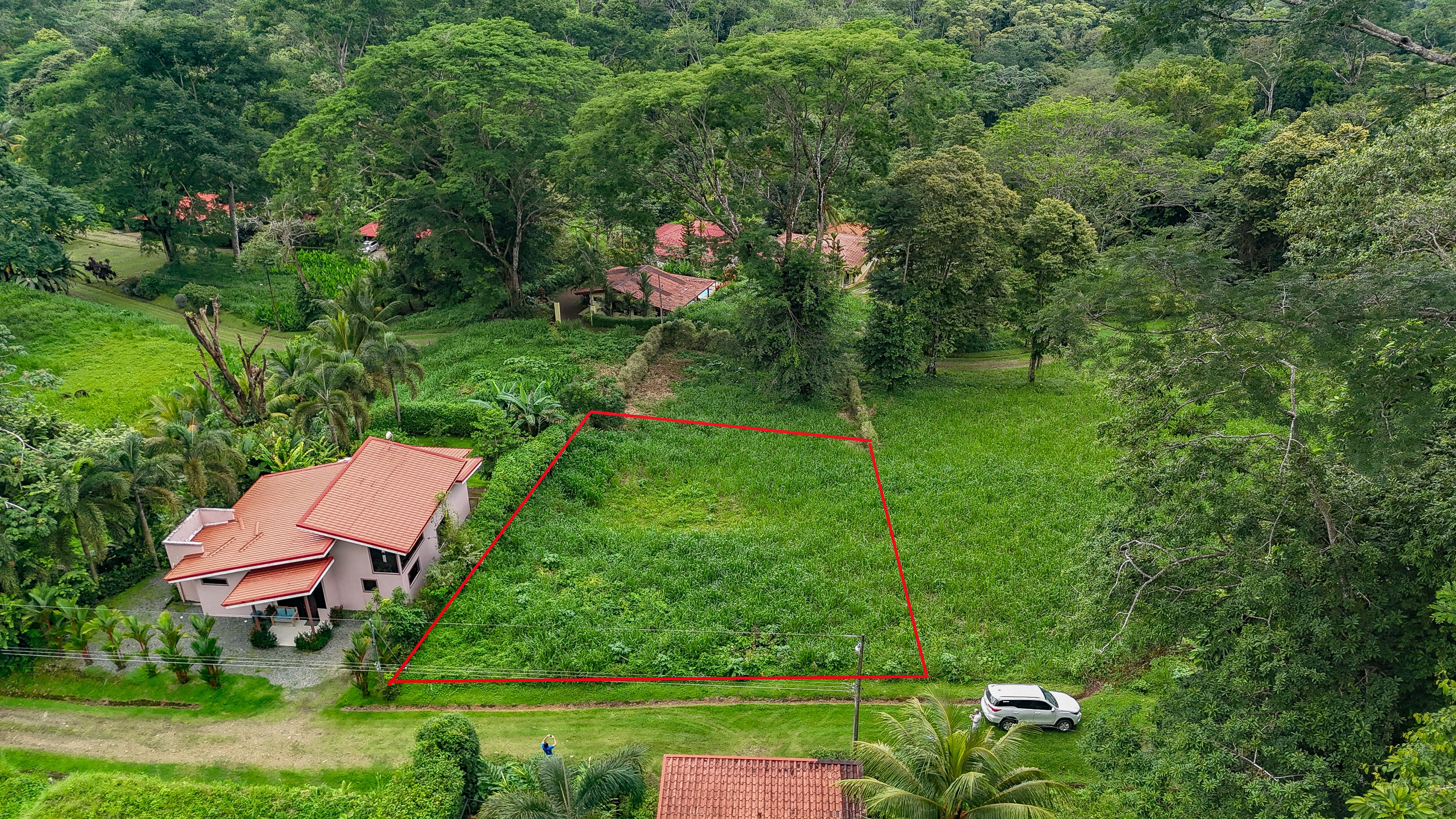 A beautiful sunny lot in a secure gated community with a nearby creek and jungle-covered valley